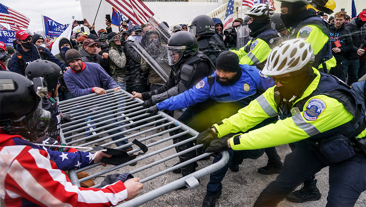 Election protesters trying to remove a guard rail during the U.S. Capitol riot