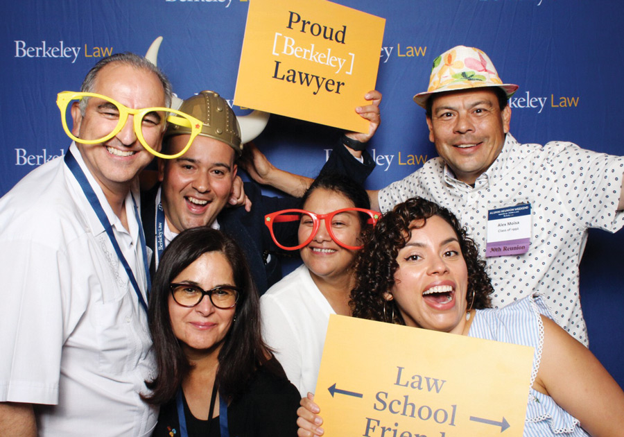 Law school students wearing party props for photo