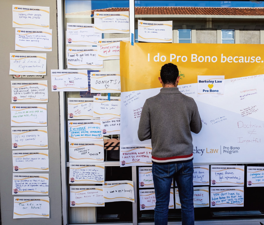 man in front of pro bono work bulletin board