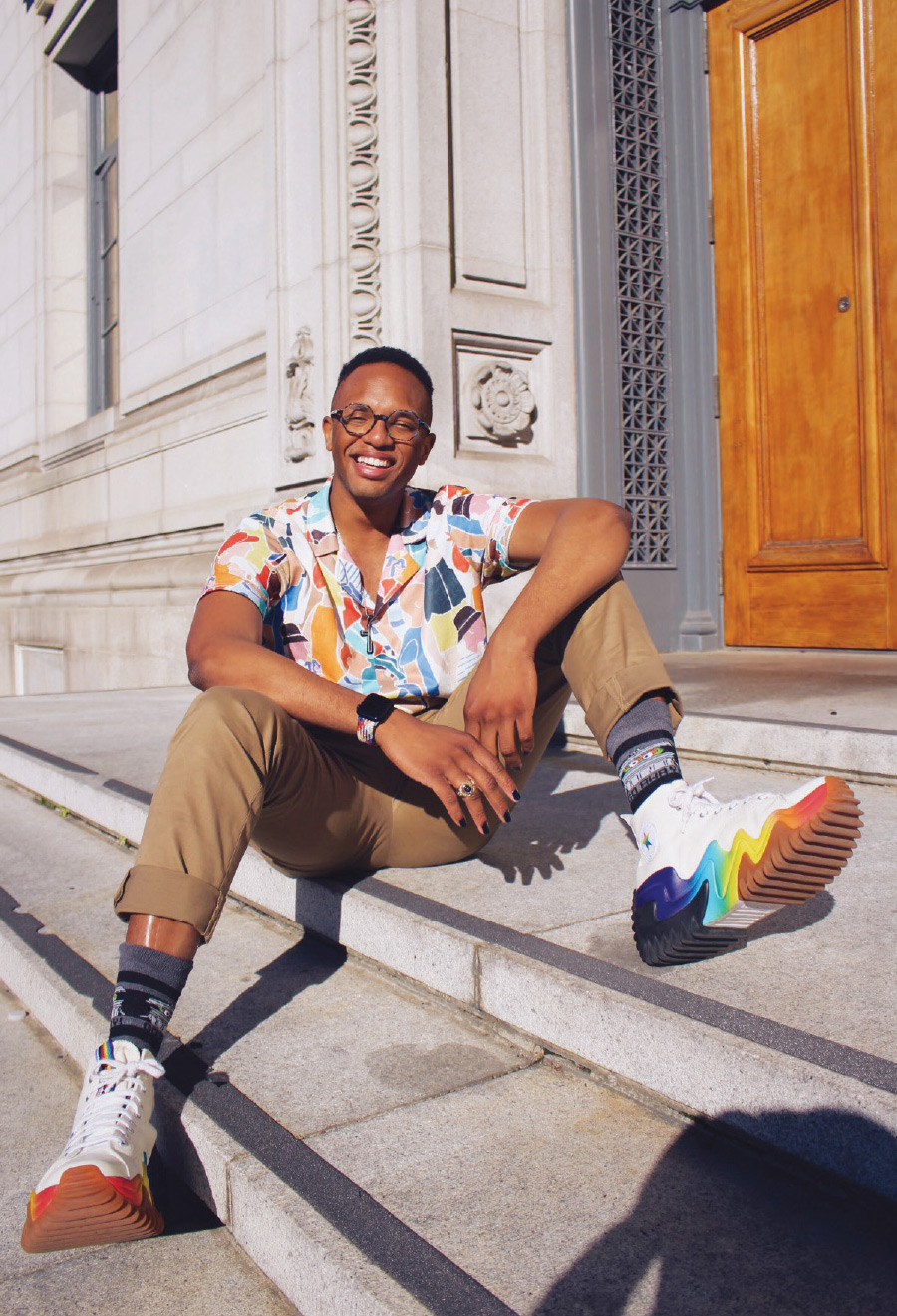 Kendrick Peterson smiling on street stoop