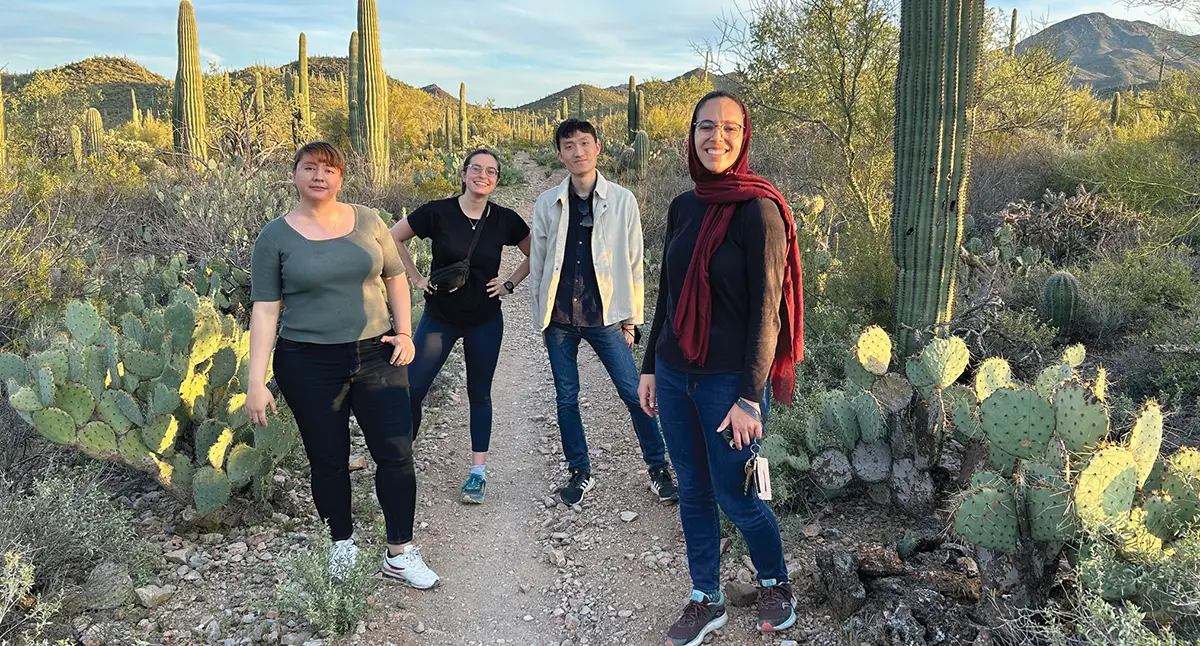 Tucson group members smiling in cactus garden