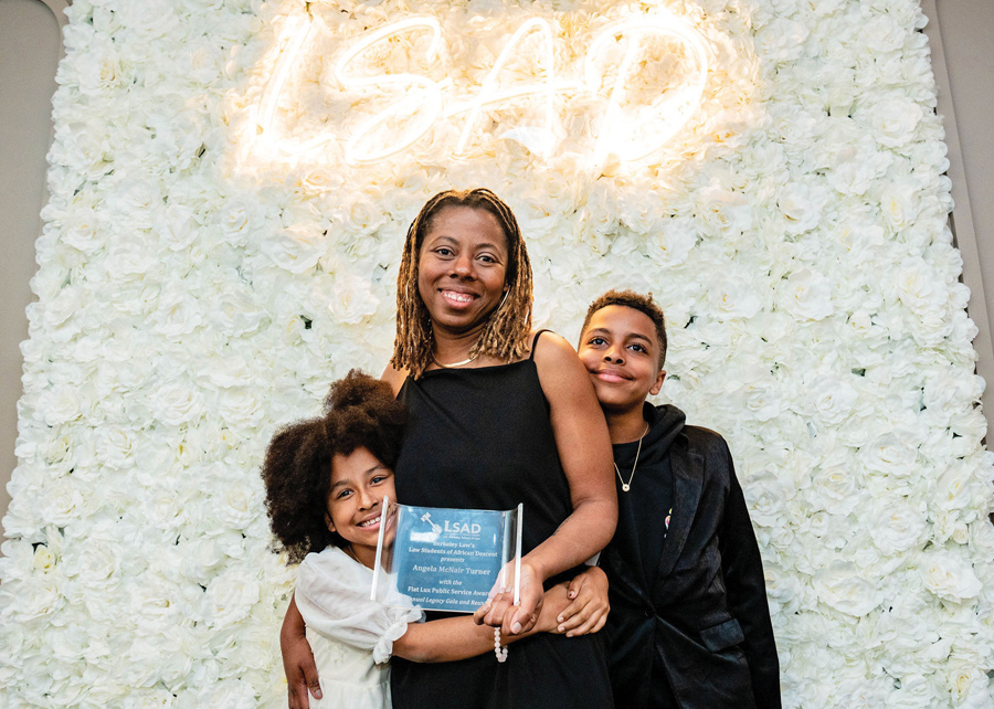 Angela McNair Turner with her children holding award