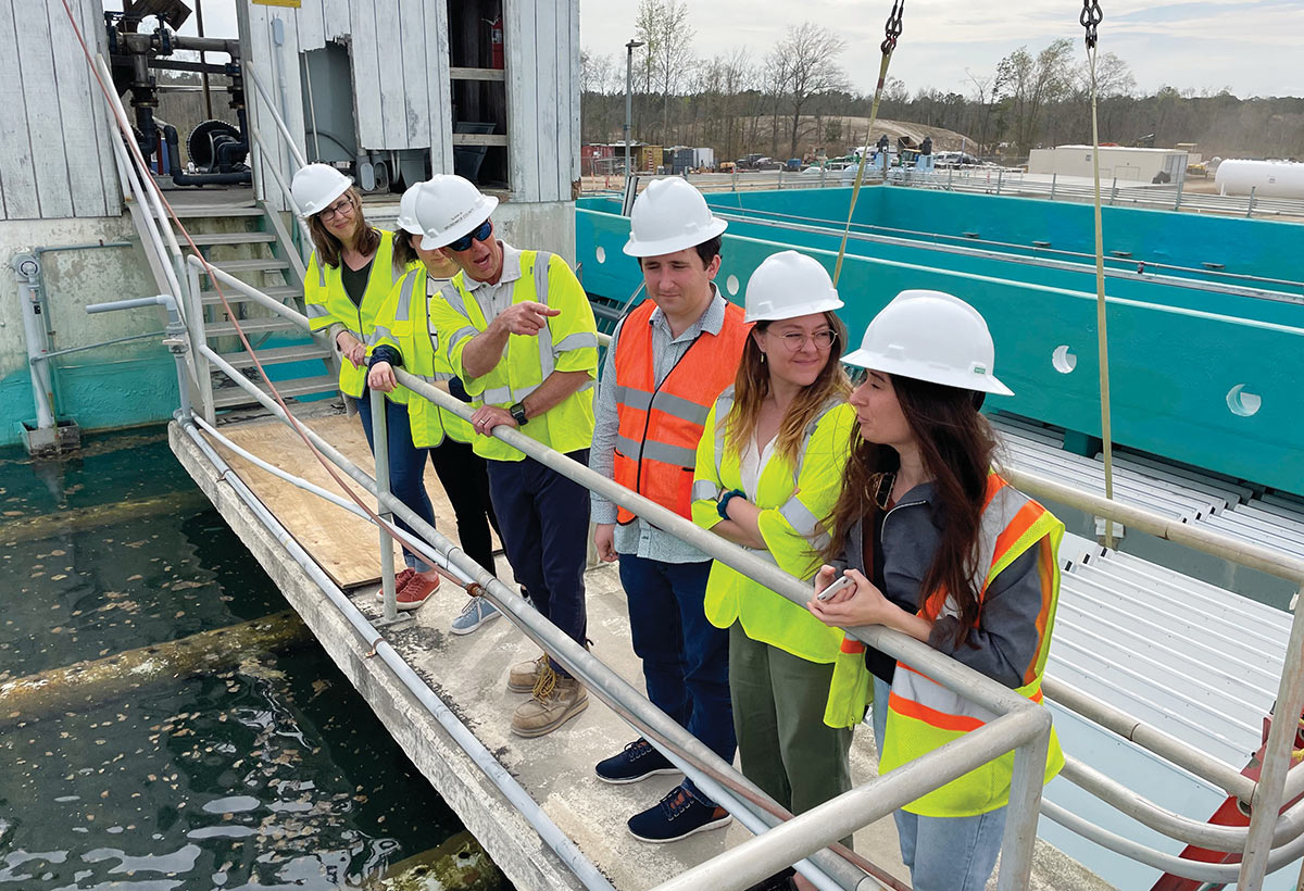 Environmental Law students in hardhats and high vis jackets at wastewater treatment plant