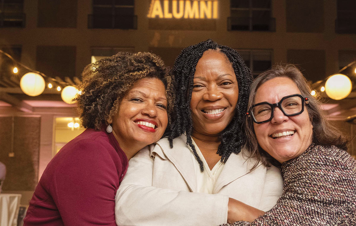 Melonie McCall, Dinah Rainey, and Yvette Verastegui smiling together at the All Alumni Celebration