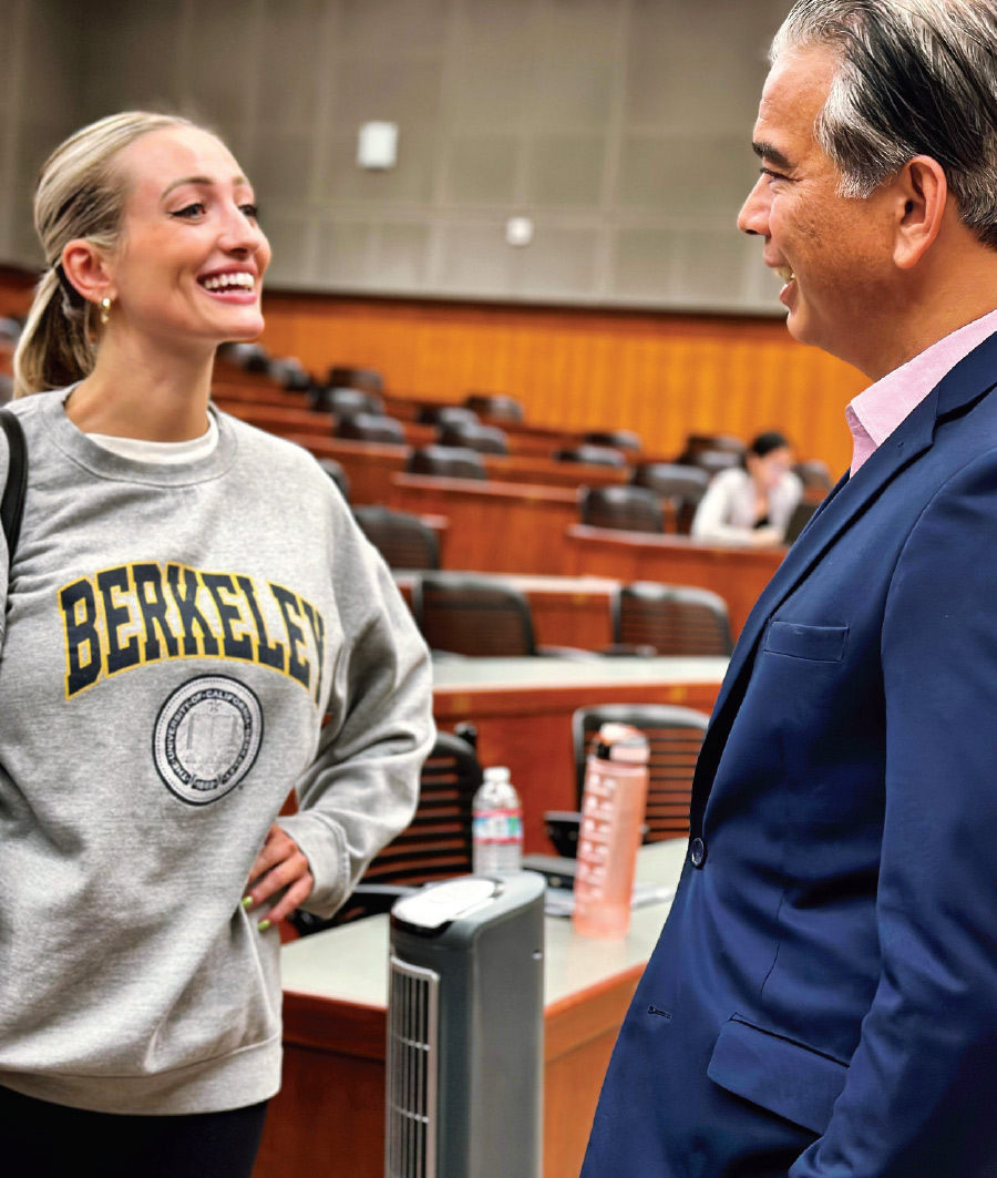 Hannah Naylor talking with Rob Bonta while wearing a Berkeley crewneck sweater