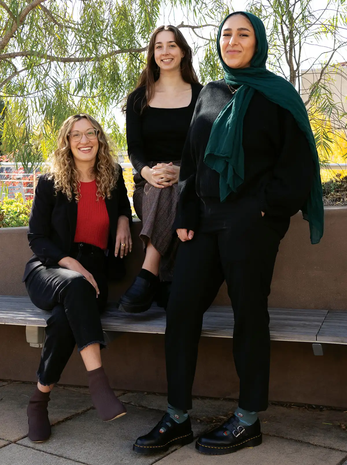 Mia Stange, Sophia Fenn, and Mariam Elbakr posing outside campus