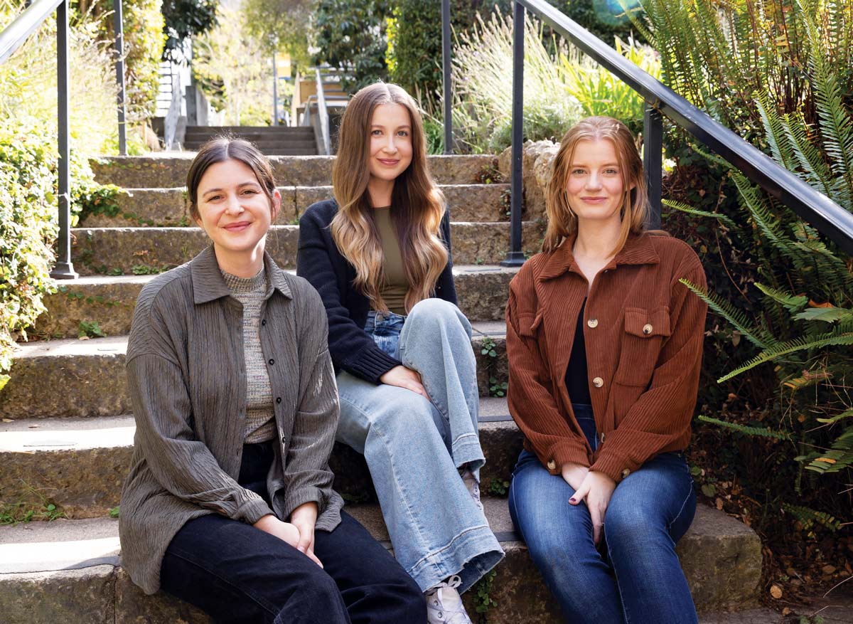 Sarah Zweig, Rachel Gaines, and Sarah O’Farrell sitting on an outdoor staircase