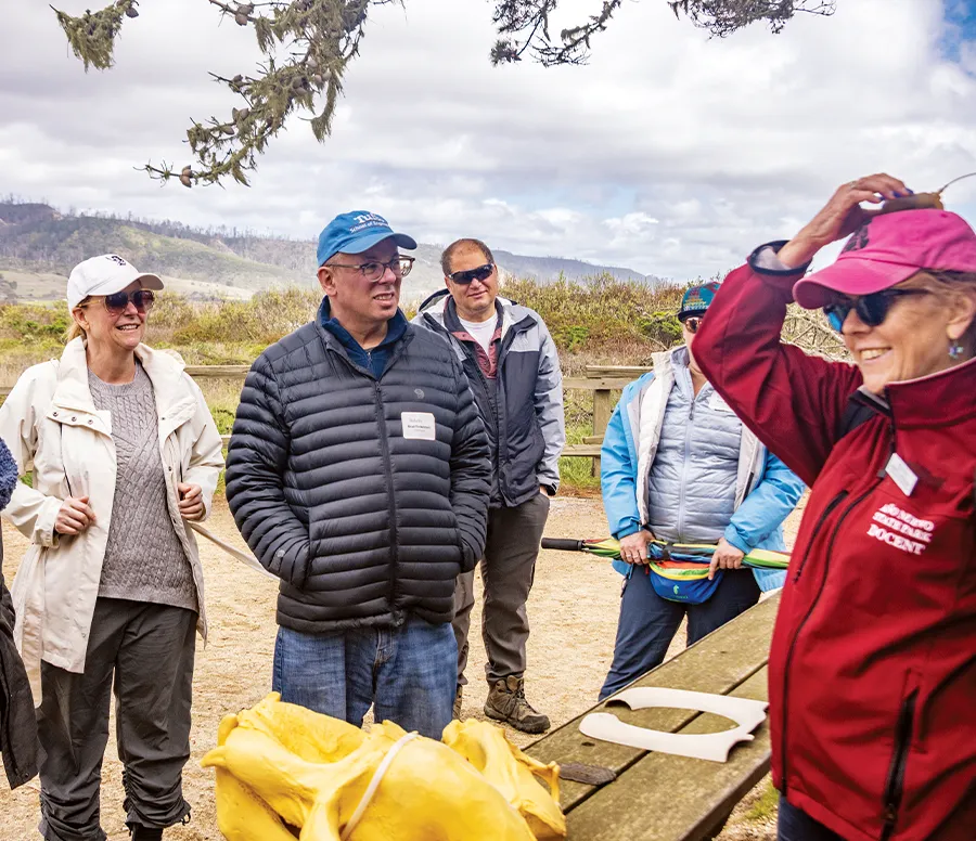 group of Silicon Valley chapter alums learning about Año Nuevo State Park from docent Olivia Iannicelli