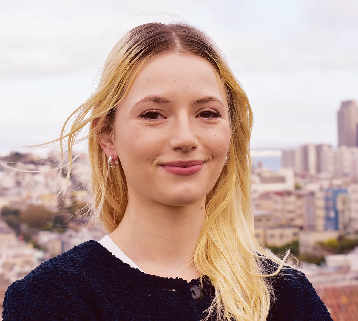 headshot of Juliette West with the city skyline the background