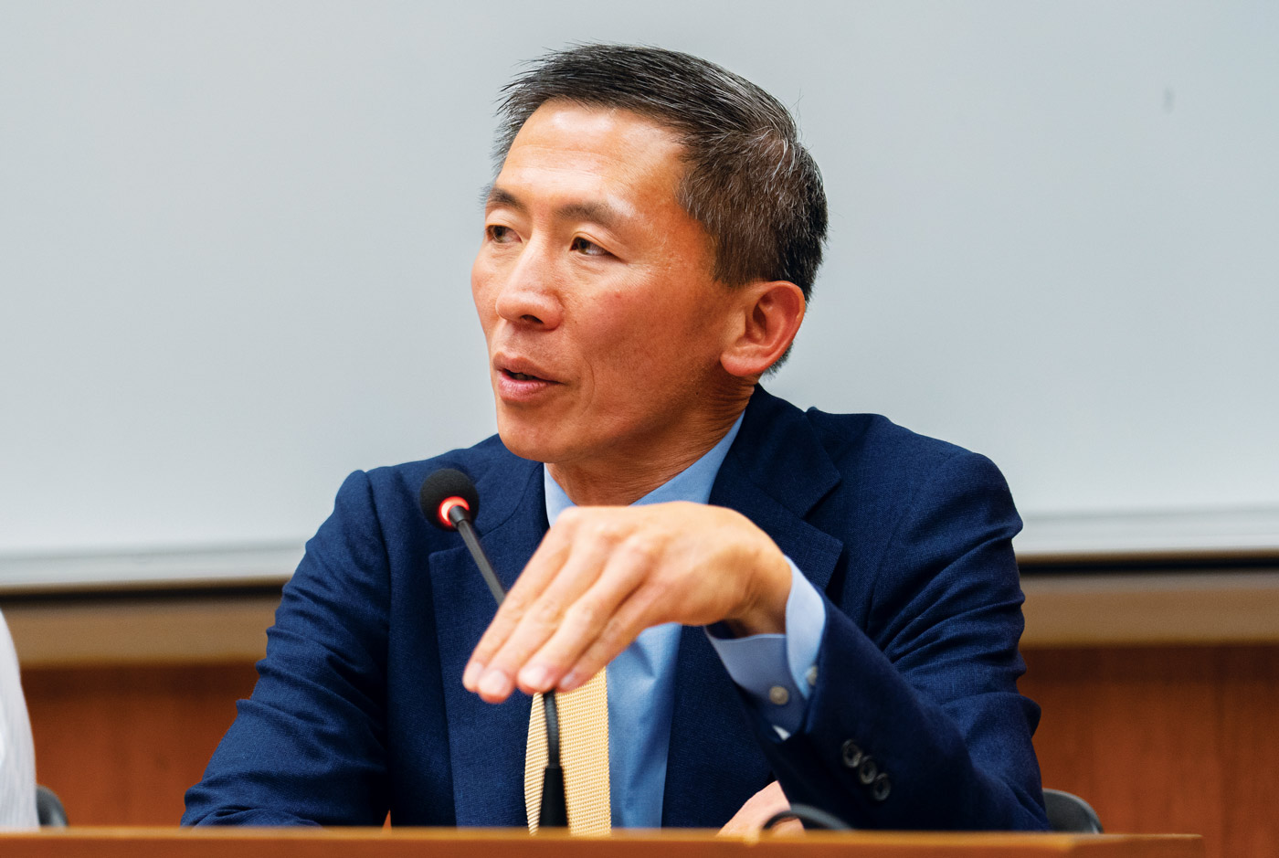 Goodwin Liu sitting at panel and speaking into microphone