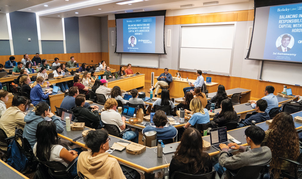 Students attending a lecture in a modern university lecture hall.